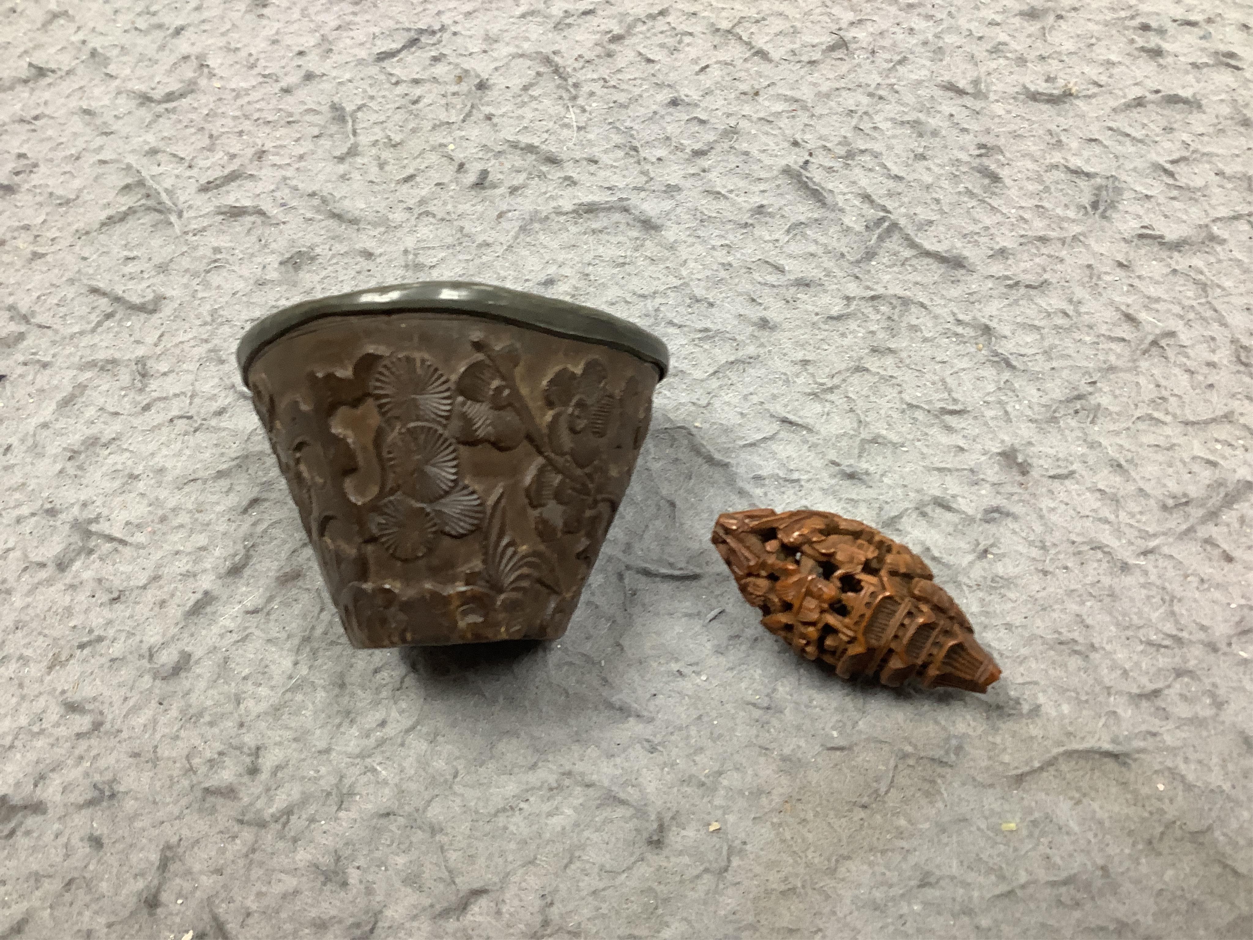 Four Chinese carved peach stones and an 18th/19th century Chinese carved wood cup, 6cm wide (5). Condition - fair to good